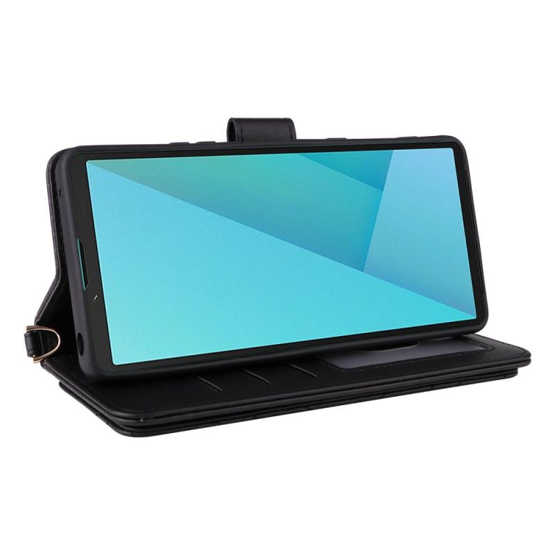 Flip Cover Sony Xperia 10 Vii Quiltet Med Rem Og Håndledsrem